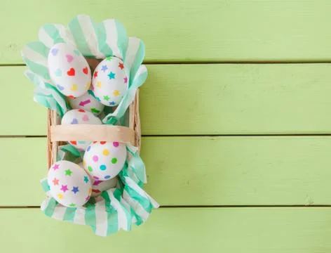 Little basket with easter eggs Stock Photos