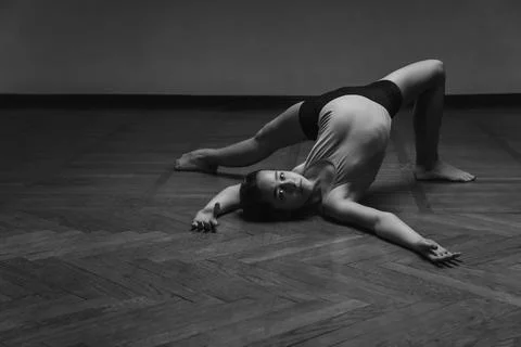 Little beautiful dancer posing in a dance hall black and white image. copy space Stock-Fotos
