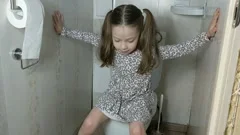 Little girl sitting on the potty beside , Stock Video