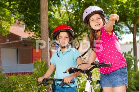 Little bike riders looking for direction in city Stock Photos
