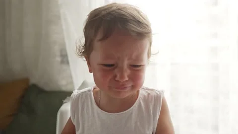 Little blond boy does not want to eat a meal that gives him a parent and cry Stockbeeldmateriaal 194989806