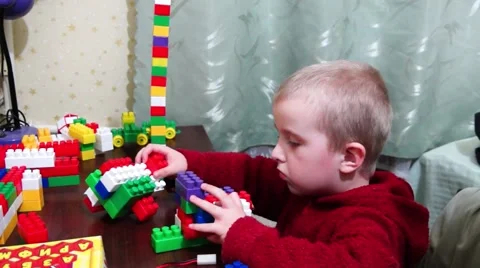 The little blond boy plays on the table designer, fools around, talking. Video stock 48989986