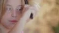 Little blond girl with blue eyes combing HD Footage