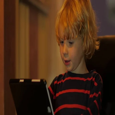 Little blonde boy talking on tablet with granny. 스톡 동영상 69725662
