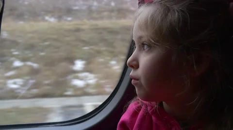 Little Blonde Girl With Her Face Bored Is Looking Through a Window of a Bus Stock Footage 59134113