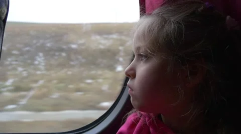 Little Blonde Girl With Her Face Bored Sleepy Kid is Looking Through a Window Stock Footage 59135372