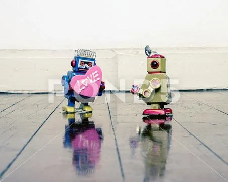 Little blue robot giving a bog pink love heart Stock Photos