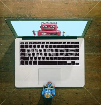 Little blue robot watching webinar Stock Photos