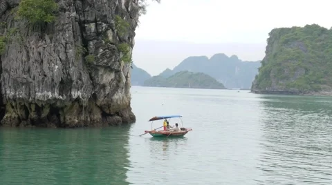 Little boat and world heritage mountains, Halong Bay, Vietnam. Tracking shot. Stock Footage 65831748