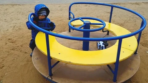 The little boy of 4 years in a jacket and trousers shakes himself on a Stock Footage 115471704