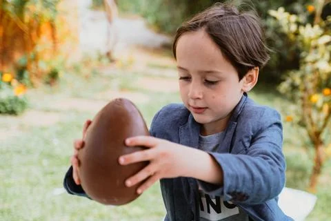 Little boy and Easter egg of ciocolate Stock Photos