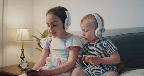 Little boy and girl child in headphones Stock Video Pond5