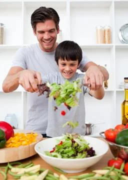 Little boy and his father cooking Stock Photos