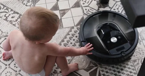 Little boy and robot vacuum cleaner on the floor 動画素材 81471253