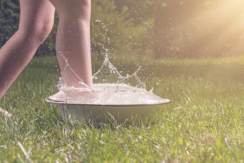 Little boy and splash of water in the summer garden Stock Photos