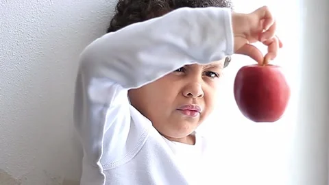 Little boy with apple on white background stock video stock footage Stock Footage 321939750