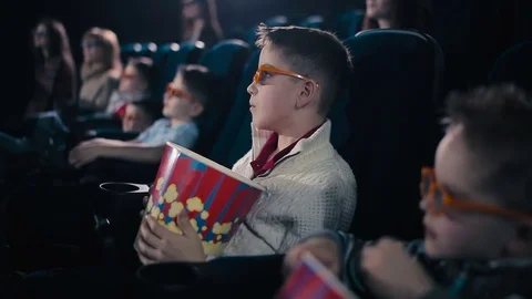 The little boy are smiling in the cinema Stock Footage