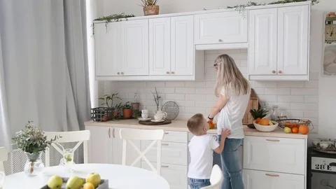 The little boy asks mom in the kitchen candy Stock Footage 76092614