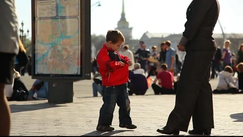 Little boy asks mother to help with clothes Stock Footage 5650475