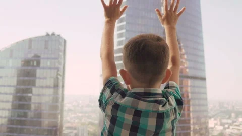 Little boy in the background with skyscrapers. Stock Footage 93588857