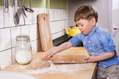 Little boy baking in the kitchen. Stock Photos