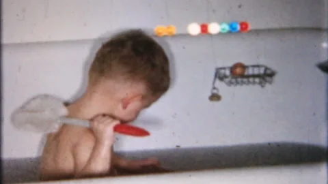 little boy in the bath tub at home mom h... | Stock Video