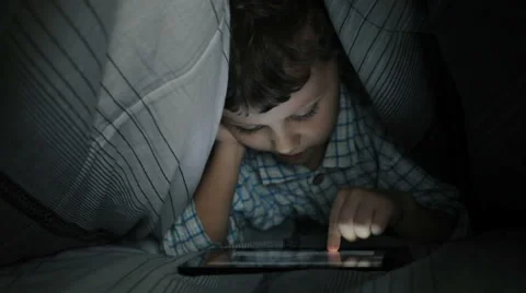 Little boy on the bed in the room using tablet Stock Footage 60575172