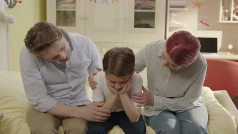 The little boy is in bed talking to his family about his problems at school. Stock Footage 198373761