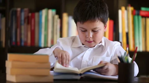 Little boy beeing bored with reading Stock Footage 46025488