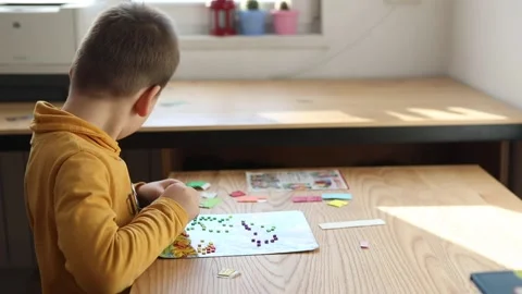 Little boy being creative making homemade do it yourself dinosaur mosaic. Stock Footage 168293629