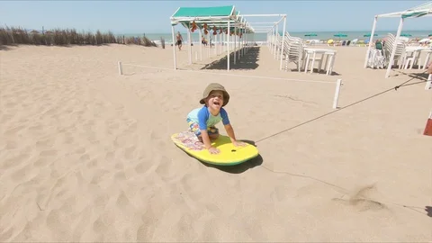 Little boy Being Pulled on a Surf board Stock Footage 130097222