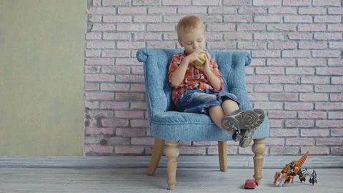 Little boy biting off apple Stock Footage 73684408