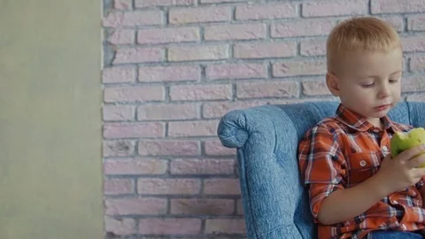 Little boy biting off apple Stock Footage 73699672