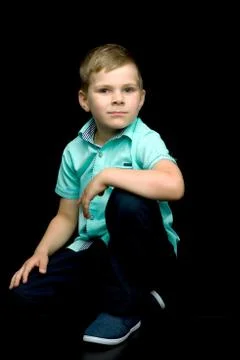 Little boy on a black background. Stock Photos