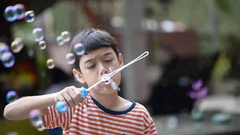 Little boy blowing bubble soap slow motion HD Stock video Stockbeeldmateriaal 73923135