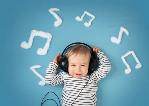 Little boy on blue blanket background with headphones Stock Photos
