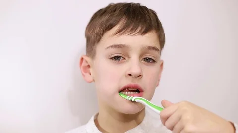 Little boy brushes teeth on white background, little baby brushes teeth Vídeos de archivo 125958662
