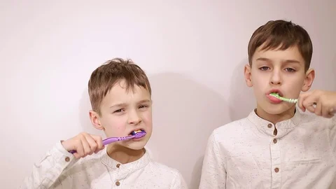 Little boy brushes teeth on white background, little baby brushes teeth Stock Footage 125958725
