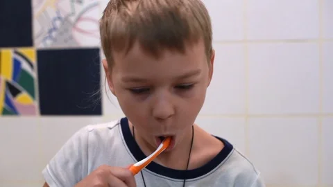 Little boy brushing his teeth in the bathroom Stock Footage 122104202