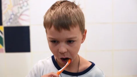 Little boy brushing his teeth in the bathroom Stock Footage 122108429