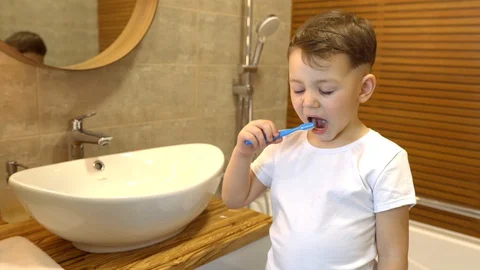 Little boy brushing his teeth in front of the camera Stock Footage 128779431