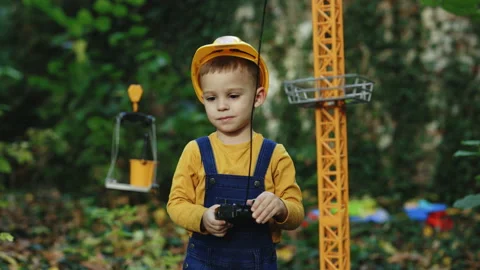 Little boy builder in uniform working on construction site. Child future Video stock 229730108