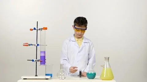 Little boy chemist in uniform, protective glasses  Stock Footage 49893506