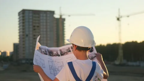 Little boy child future engineer builder architect with safety helmets with Stock Footage 139205774