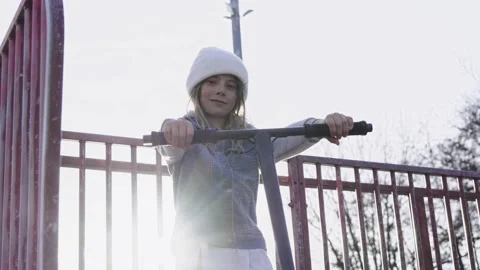 Little boy child model poses happily for video holding skateboard outdoors Stock Footage 238486538
