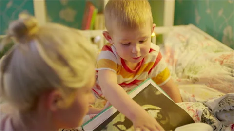 Little boy choosing next bedtime story Stock Footage 62732028