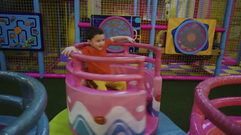 A little boy circles himself on a carousel Stock Footage 169395693