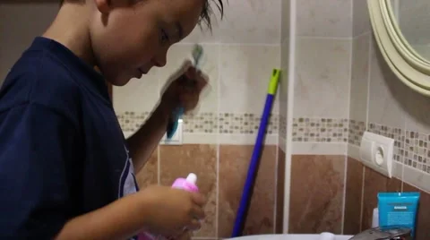 The little boy cleans his teeth in front of mirror Stock Footage 65302550