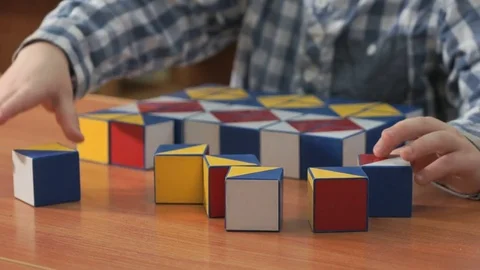 Little boy collecting pattern using colored cubes Video stock 84240855