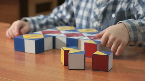 Little boy collecting pattern using colored cubes Stock Footage 87575131
